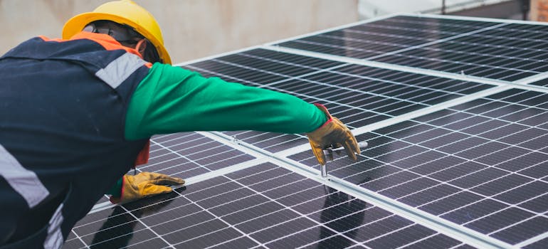 A man installing solar panels.
